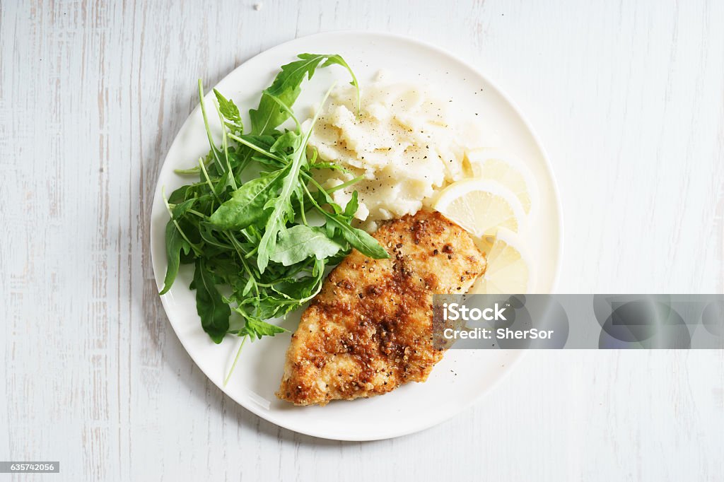 Lemon Pepper Chicken steak Lemon and Pepper Chicken steak served with mashed potato and fresh arugula salad Plate Stock Photo