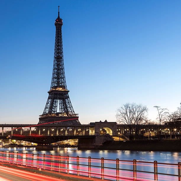 istock Sunrise in Paris behind the Eiffel Tower with trail lights 635747112