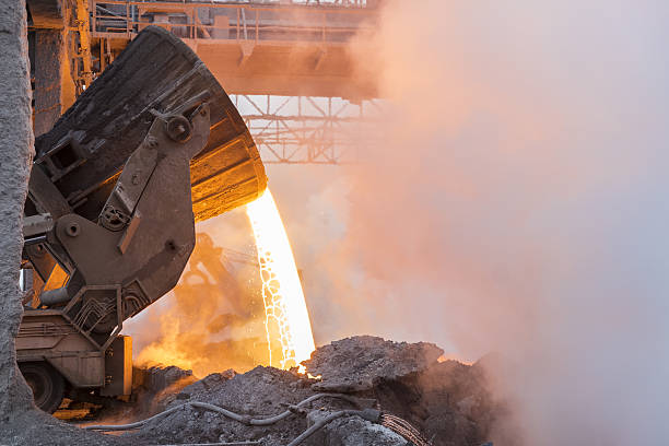 Metallurgy Heavy industry. Part of the process in metallurgy. Pouring the hot melt from the vat. power equipment stock pictures, royalty-free photos & images