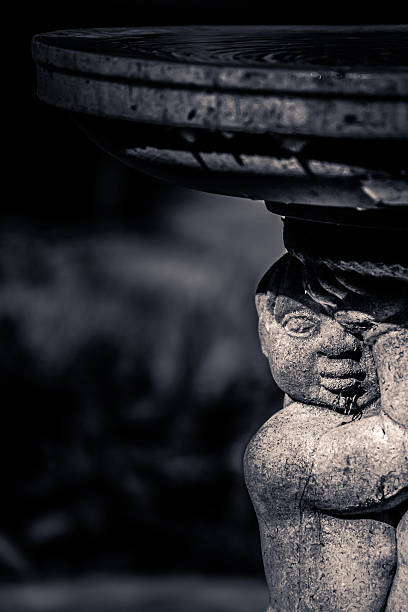 A moody looking boy statue.