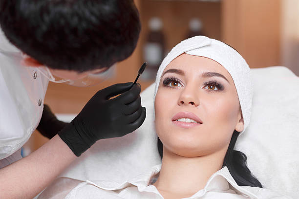 istock Beautiful young woman gets eyebrow correction procedure 635747986