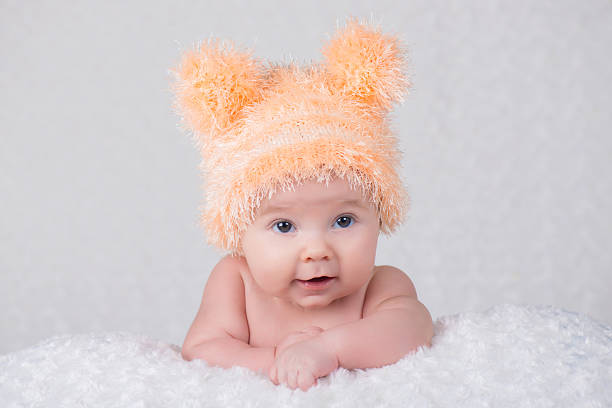 istock Newborn baby in a knitted cap with ears. 635749548