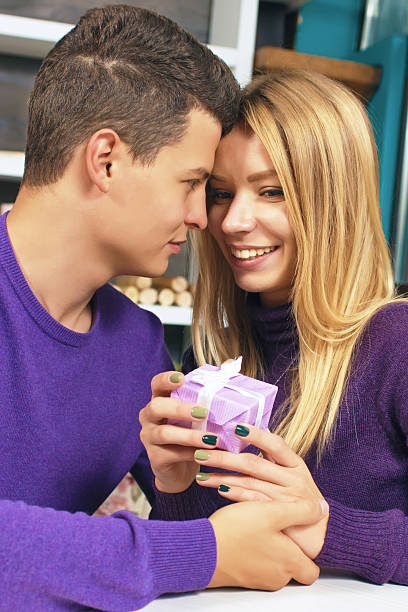 istock Young man giving a gift to his girlfriend 635753534