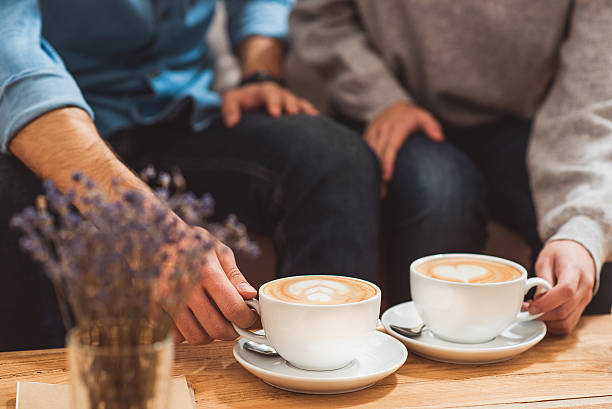 istock Lovers enjoying hot beverage on date 635754718