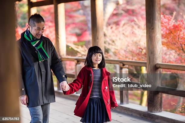 Father And Daughter At A Temple Enjoying Autumn Leaves Stock Photo - Download Image Now