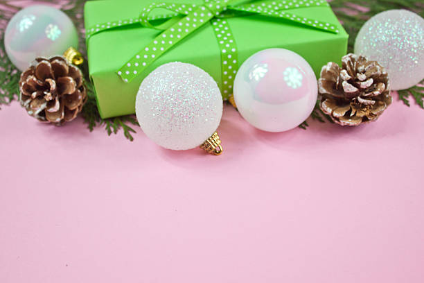 istock Green gift with Christmas decoration on pink background 635755596