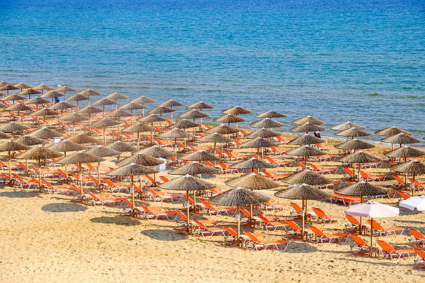 istock Beach umbrella and sunbeds on the sandy beach in Greece 635756470