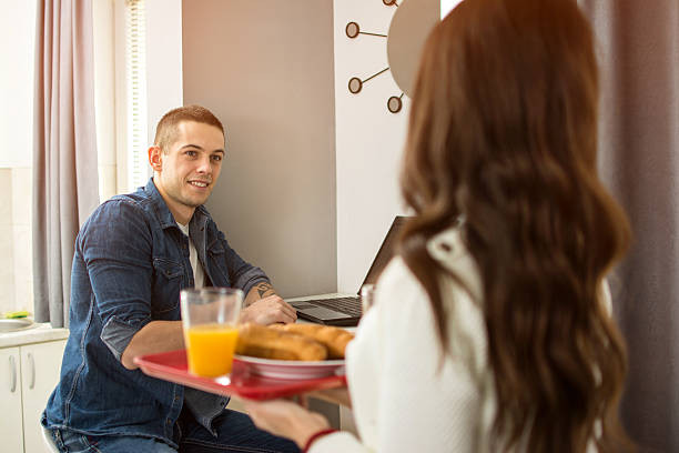 istock Girlfriend bringing breakfast to his boyfriend. 635759092