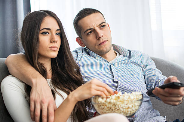 istock Young couple watching a movie at home. 635759780