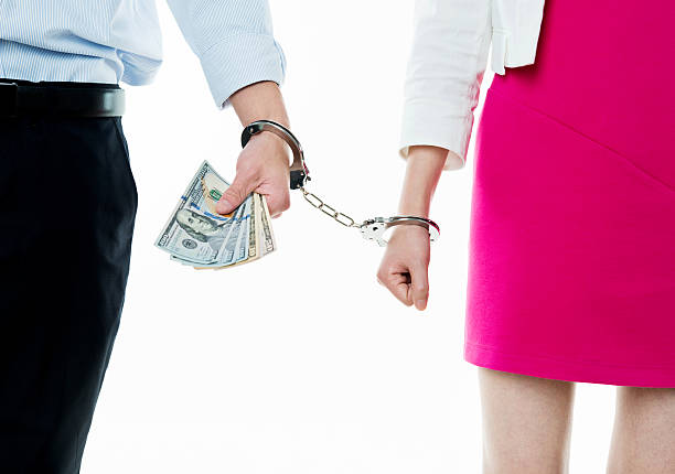 istock Handcuffed man and woman hands 635759812