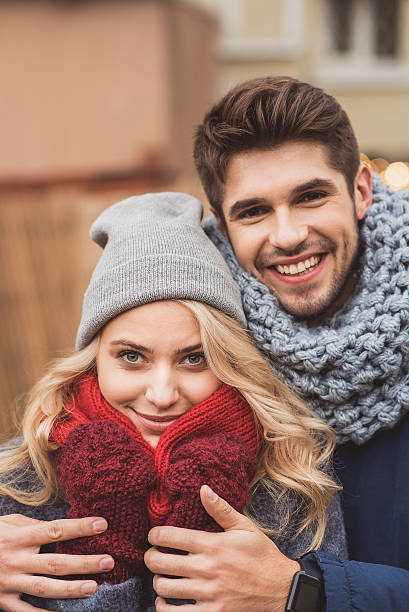 istock Joyful loving couple keeping warm by hug 635763676