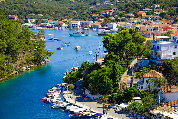 Old harbour of Paxos island with boat entering the grand stock photo