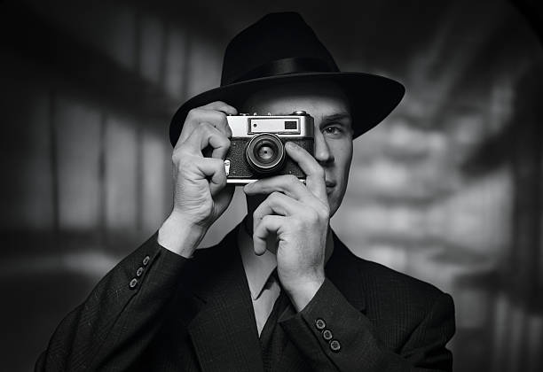 istock 1950s man in hat taking a picture 635766136