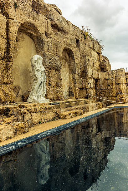 Roman emperor statue reflecting in a pool in Caesarea in Israel