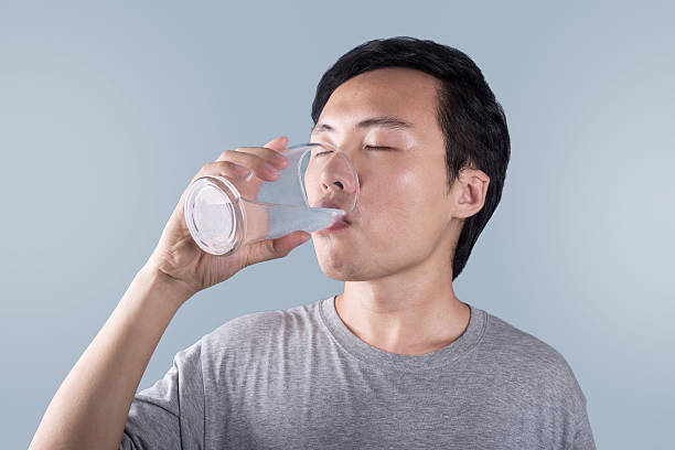 Asian man drinking water stock photo