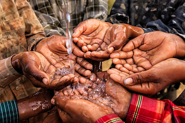 Poor Indian children asking for fresh water, India Poor Indian children keeping their hands up and asking for support. begging social issue photos stock pictures, royalty-free photos & images