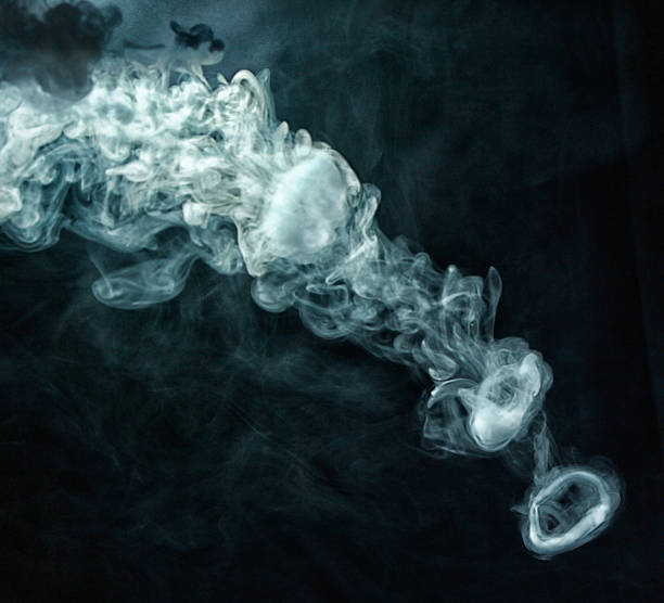 istock Vape trick smoke ring on dark background 635771114