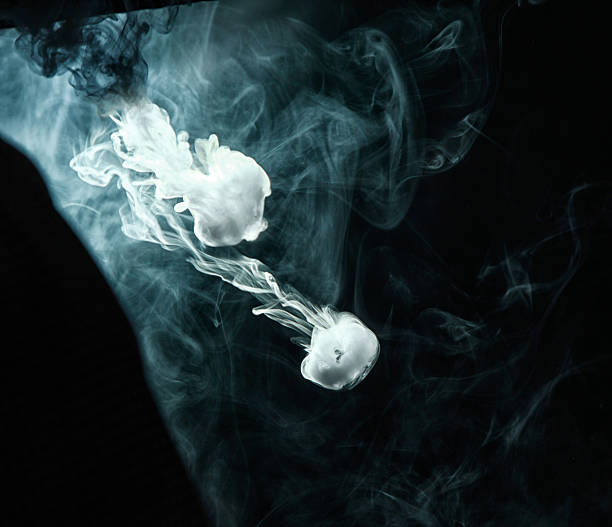 istock Vape trick smoke ring on dark background 635771192