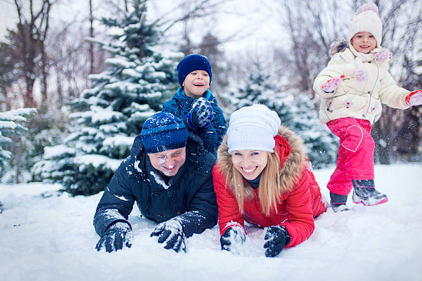 istock Attractive family having fun in a winter park 635771920