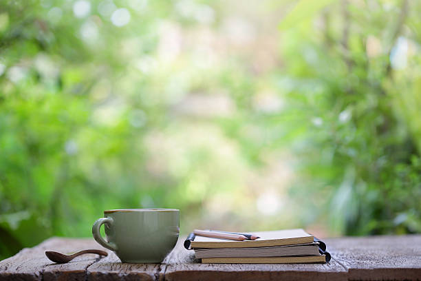 istock Notebook with pencil and vintage tea cup on wooden table 635772416