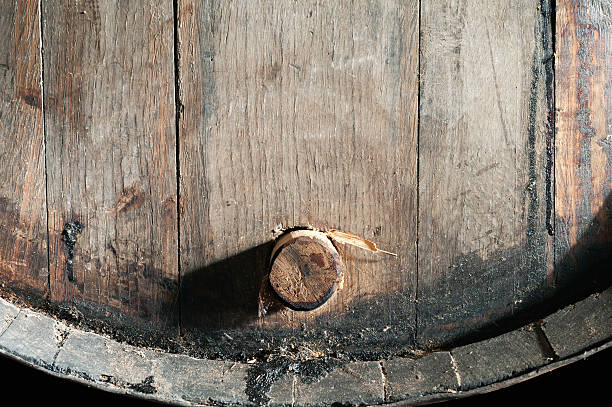 Closeup of old oak barrel. Front view. Closeup of old oak whiskey, wine, madeira, rum, buorbon, cognac, brandy, porto barrel. Front view. cognac region photos stock pictures, royalty-free photos & images