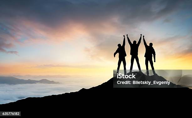 Silhouette Of The Team Stock Photo - Download Image Now - Mountain, On Top Of, Teamwork