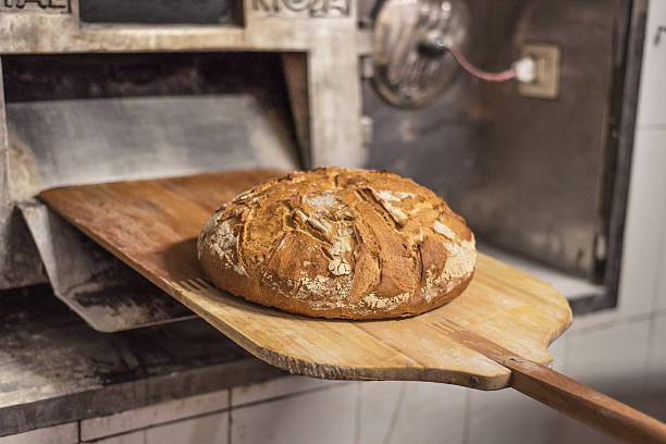 Baking bread in shovel at the bakery