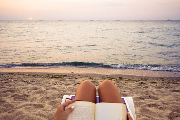 istock Woman reading book relaxed in deck chair 635779206
