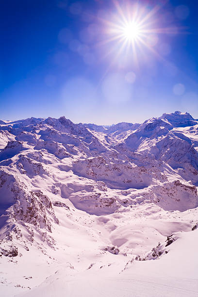 istock winter extremely highly mountains clouds sun beam bokeh abstract background 635780786