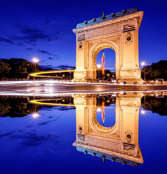 Bucharest, Romania. Arc de triomphe. Night panoramic view. Artistic interpretation, mirror effect.