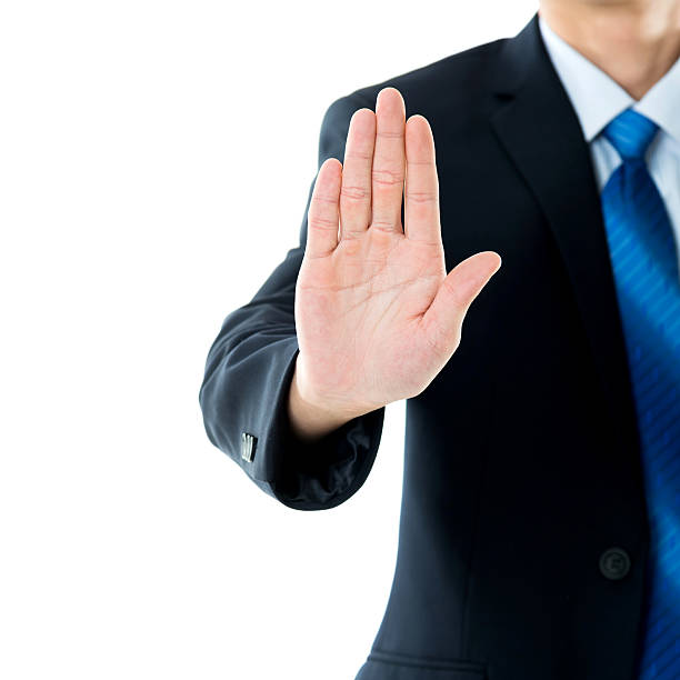 istock Businessman show STOP against white background 635782546
