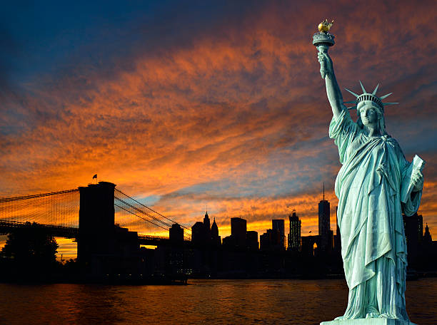 istock Statue of Liberty and Manhattan at sunset. 635784454