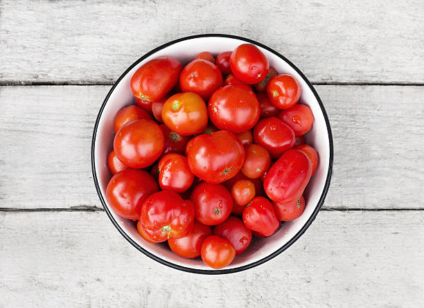 istock Tomatoes in a metal bowl on a wooden table 635785070