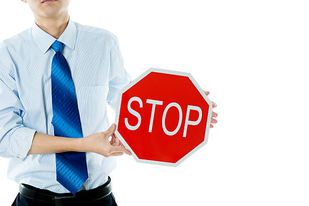 Portrait of young African businessman wearing white shirt with black necktie against white background