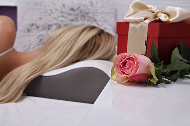istock Woman sleeping with flower and present on pillow 635786942