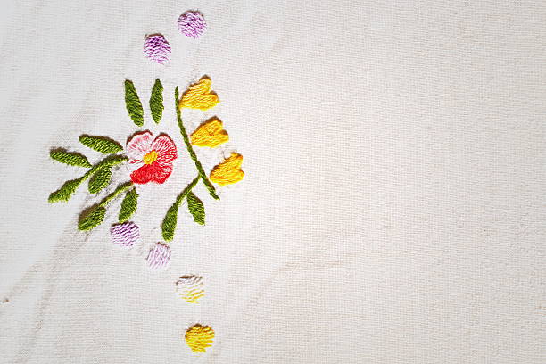 istock Red flower embroidered on canvas 635787368