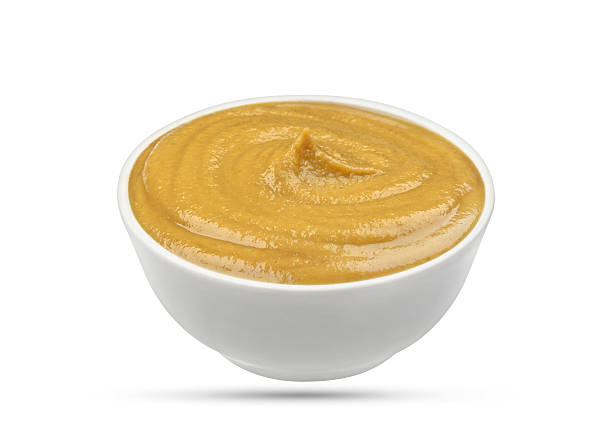 istock Mustard in bowl isolated on white background 635787420