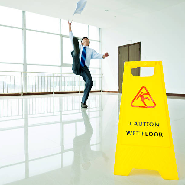 istock Businessman slipping on wet floor 635787918