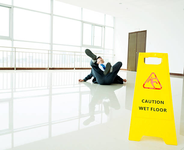 istock Businessman slipping on wet floor 635788242