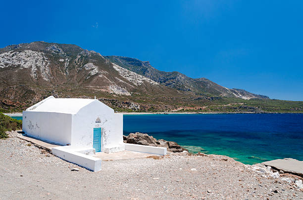 istock White church beside blue sea. 635788294