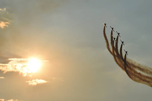 istock Acrobatic planes doing acrobatics at an Airshow flying at sunset 635788806