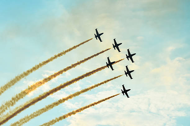 istock Acrobatic planes doing acrobatics at an Airshow flying at sunset 635788834