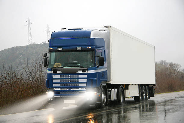 Lorry truck on highway Semi-truck on highway driving on road at rain day truck rain stock pictures, royalty-free photos & images