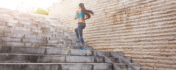 istock Unrecognizable woman running up on stairs 635790292