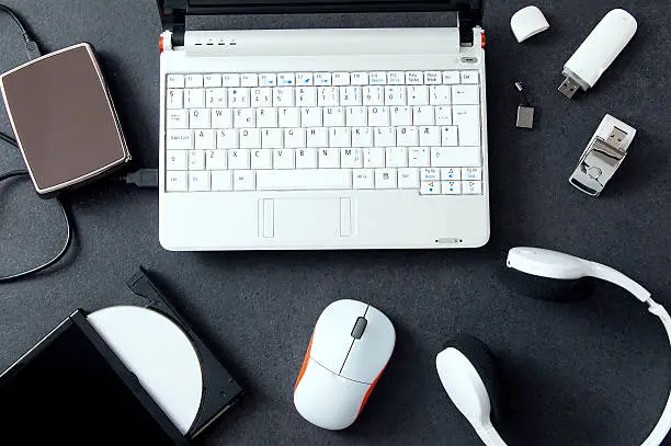 Photo of Computer peripherals & laptop accessories. Composition on stone