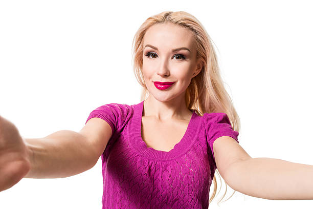 istock Blonde doing selfie on isolated white background. Taking picture. 635791994