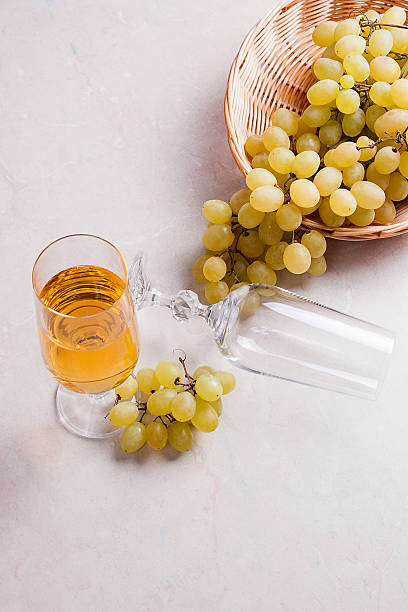 istock White wine and grapes. White wine in glass and grapes 635792662