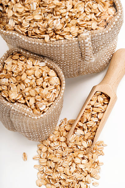 istock Uncooked oat flakes in burlap sack 635794592