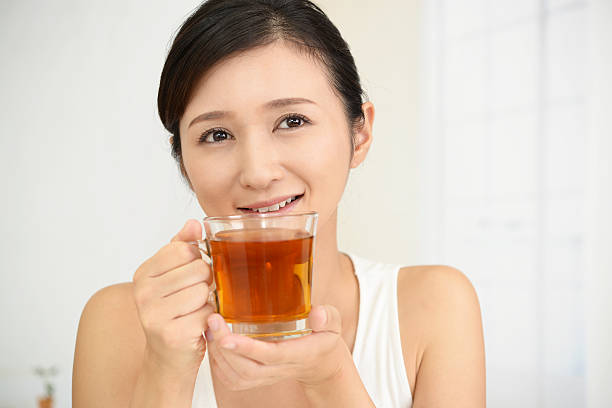 istock Woman drinking a glass of tea 635796088