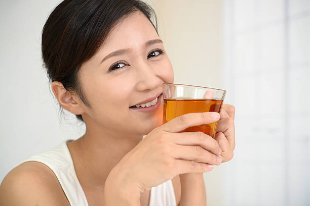 istock Woman drinking a glass of tea 635796176